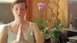 Italian pregnant woman doing yoga at home. Rack focus