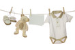 Baby goods and blank note hanging on the clothesline Baby goods and blank note hanging on the clothesline