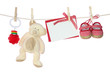 Baby goods and blank note hanging on the clothesline Baby goods and blank note hanging on the clothesline