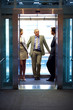 Foto: Successful business people standing in office elevator Successful business people standing in office elevator