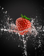 fresh strawberries in a spray of water
