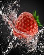fresh strawberries in a spray of water