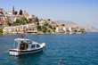 Small yacht on sea bay of symi island, Greece