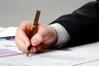 Male hand is writing in business document Male hand is writing in business document