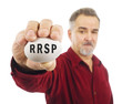 Mature man holds an egg with RRSP on it. Mature man holds an egg with RRSP on it.