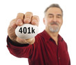 Mature man holds a white nest egg with 401k on it. Mature man holds a white nest egg with 401k on it.