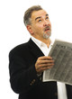 Man looks skyward after reading newspaper with look of despair Man looks skyward after reading newspaper with look of despair