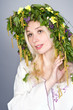 Beautiful blonde girl in folk costume and chaplet