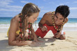 couple discover a small crab on lanikai beach
