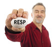 Mature man holds a white nest egg with RESP on it. Mature man holds a white nest egg with RESP on it.