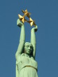 Woman's sculpture, holding tree golden stars Woman's sculpture, holding tree golden stars