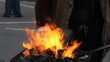 Blacksmith heats up the iron in the fire
