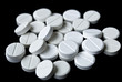 Scattering of white tablets on black background Scattering of white tablets on black background