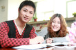 asian boy and girl studying in library