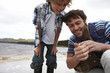 Father and son looking at ladybug