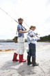 Father and son fishing at a lake