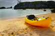 Sea kayak on the shore with scenic background