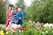 Photo: Beautiful young family in spring park Beautiful young family in spring park
