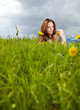 Beautiful woman lying on the grass in the summer park