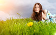 Beautiful woman lying on the grass in the summer park