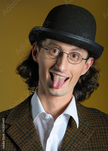 Photo: Funny man in glasses with long tongue Funny man in glasses with long tongue