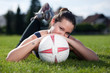 Cute young woman with a soccer ball