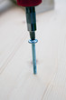 screwdriver, screw and wood planks