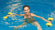 Woman in water with dumbbells