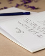 Foto: Opened wedding guest book with a pen Opened wedding guest book with a pen