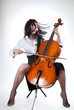 Sensual girl playing cello and moving her hair