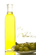 A bottle of olive oil with olives on white background