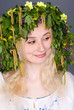 Beautiful blonde smiling girl in folk costume and chaplet