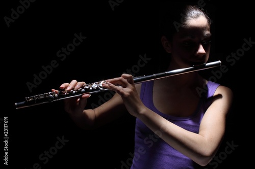 Photo: Girl playing a flute Girl playing a flute