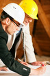 Architect and construction engineer discussing plan