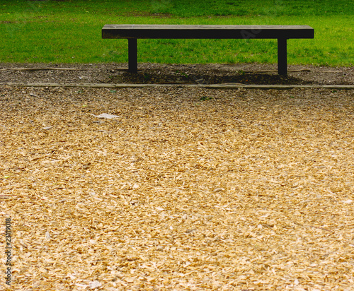 Photo: Empty Bench Between Sawdust and Grass Empty Bench Between Sawdust and Grass