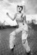 Fashion model standing behind net webbing