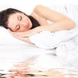 Cute woman sleeps on the white bed