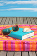 Buch mit Sonnenbrille auf Kissen