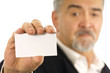 Closeup of mature businessman holding a blank business card Closeup of mature businessman holding a blank business card