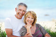 Close-up portrait of a mature couple smiling and embracing.