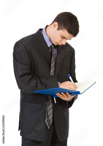 Photo: Young man holding book isolated on white background Young man holding book isolated on white background