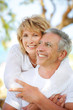 Image : Close-up portrait of a mature couple smiling and embracing.