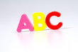 multicoloured bright plastic letters ABC on white background