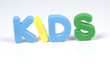 multicoloured bright plastic letters KIDS on white background