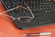 laptop, glasses and pen