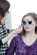 optometry concept - pretty young woman having her eyes examined