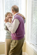 Photo: Loving senior couple dancing in living room Loving senior couple dancing in living room