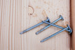 four steel screws on wood plank four steel screws on wood plank