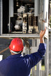 Electrician inspecting wires in electric panel