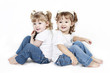 Adorable little twin girls isolated on white background Adorable little twin girls isolated on white background